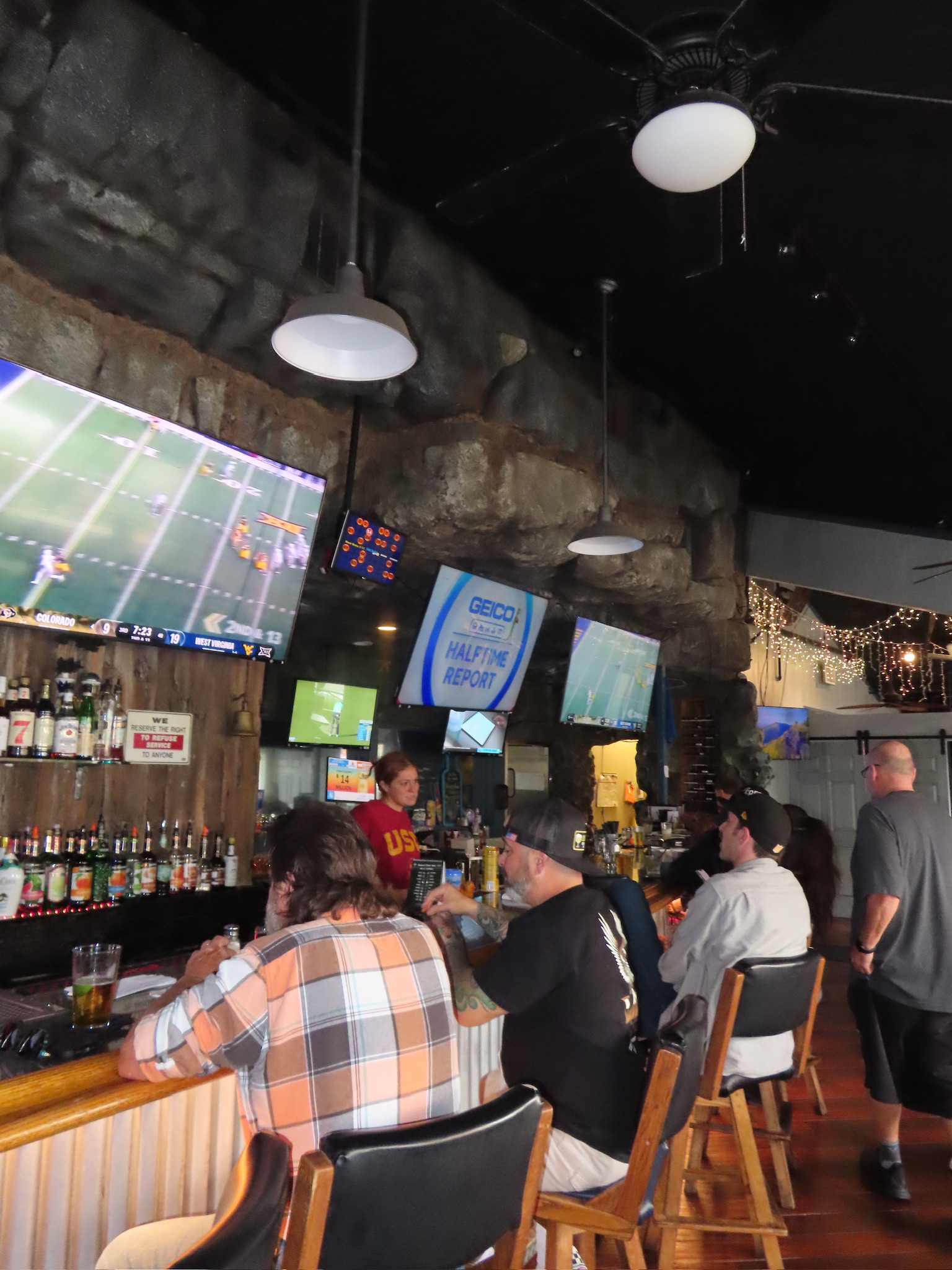 Guests watching football at Marni's — bar packed, every TV on